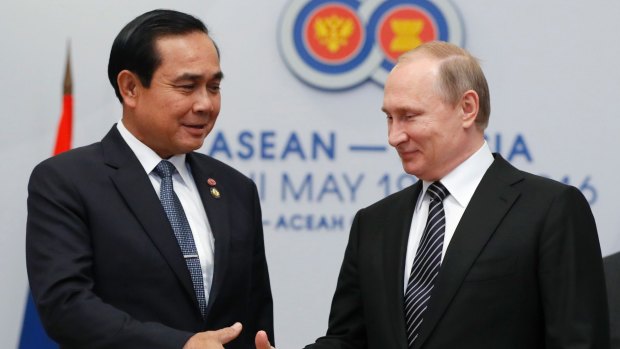 Russian President Vladimir Putin, right, shakes hands with Thai Prime Minister Prayut Chan-ocha on the sidelines of the ASEAN Summit in Russia in May.