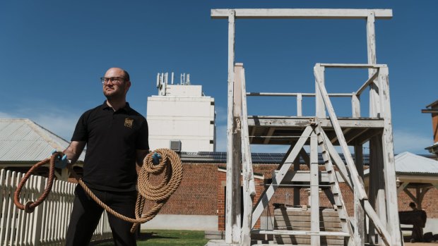 Christopher Anemaat, the gaol's visitor experience officer, shows off one of the hangman's nooses in front of the gallows replica.
