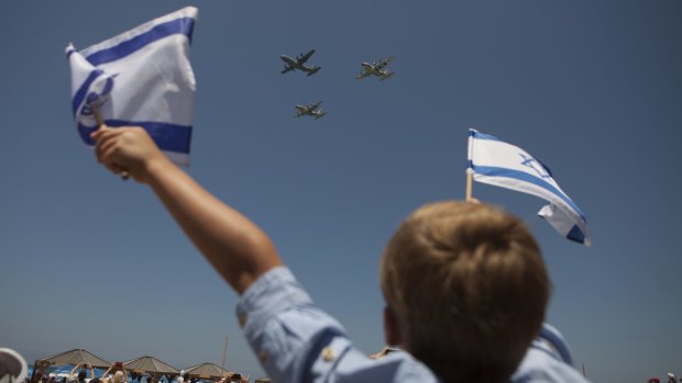 Israelis watch an air show during Independence Day celebrations in Tel Aviv.