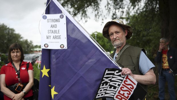 A pro-European supporter holds the EU flag ahead of a campaign visit by Labour leader Jeremy Corbyn.