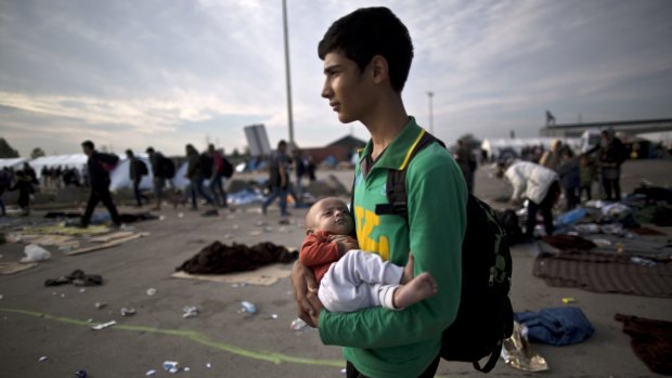 Afghan refugee Rasoul Nazari, 15, holds his 10-month-old nephew Imran after crossing the border between Hungary and Austria in Nickelsdorf, Austria. Afghans make up the second-largest nationality - after Syrians - arriving on Europe's shores, accounting for nearly a fifth of total arrivals, according to the United Nations.  