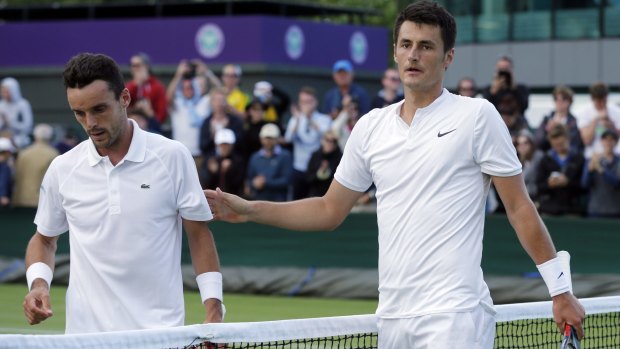 Tomic and Bautista Agut leave the court after their third round match.