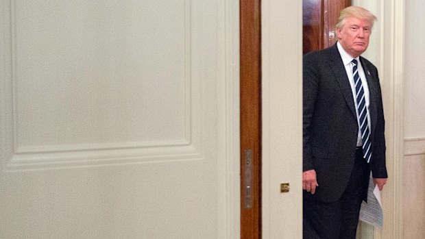 US President Donald Trump walks into the State Dining Room of the White House on Thursday.