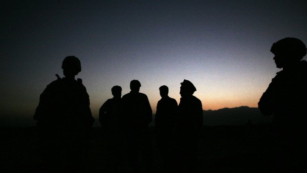 US Army soldiers stand with Afghan policemen before a joint patrol of Qalanderkhail, outside of Bagram Air Field in Afghanistan. File photo.