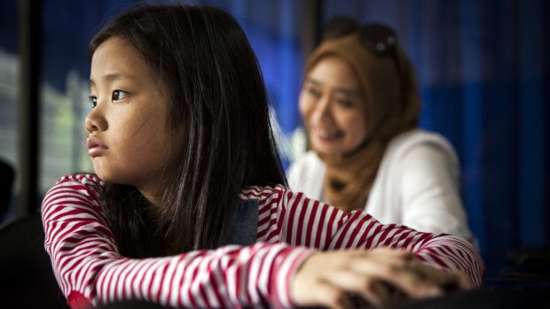 Soraya Syakieb with her mother Novi Poespita Candra (in the background). The family has moved back to Indonesia and are helping local schools become more fun for students by introducing Australian teaching methods.