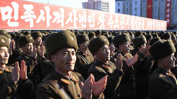 North Korean military personnel clap hands in a rally, after North Korea said Wednesday it had conducted a hydrogen bomb test last week. 