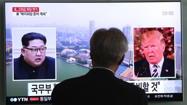 A man watches a TV screen in Seoul as the summit meeting in Singapore is previewed.