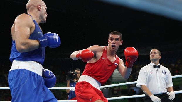 Evgeny Tishchenko of Russia (red) fights Vassiliy Levit of Kazakhstan for the gold medal.