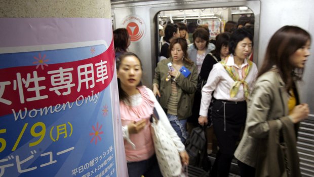 Passengers get off a "women only" train carriage in Tokyo.  ''Chikan'', or men groping women on crowded trains, is a widespread issue.