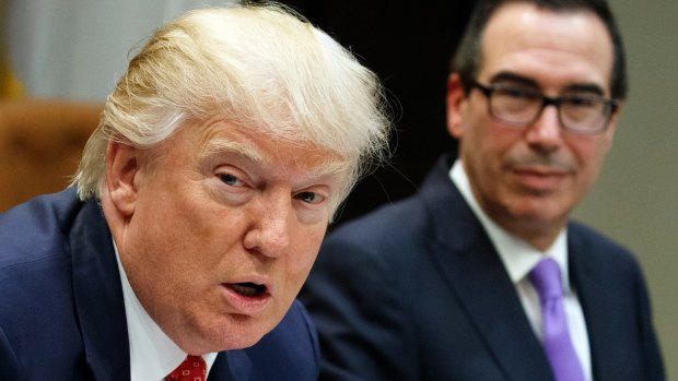 Treasury Secretary Steven Mnuchin listens at right as President Donald Trump speaks during a meeting on the Federal budget last month.