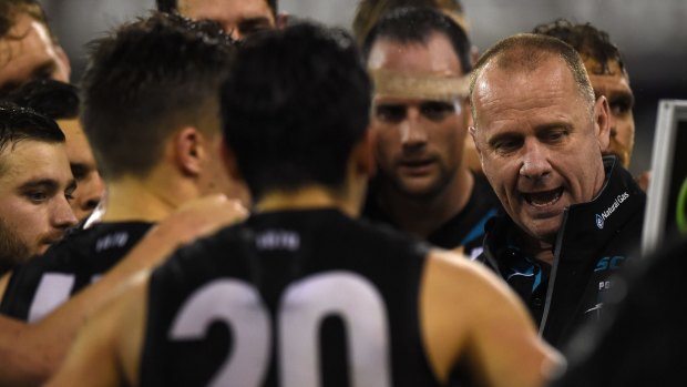 Port Adelaide coach Ken Hinkley speaks to his players during the round 22 clash.