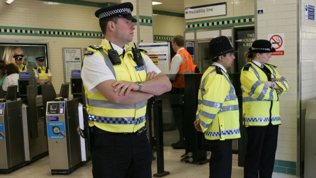 Police at Russell Square underground station, London, on the day it reopened after the July 7, 2005 attacks. 