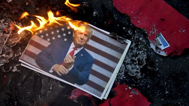 A portrait of Donald Trump is set on fire last month by Iranian protesting his decision to recognise Jerusalem as capital of Israel.
