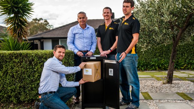 Smart Delivery Systems' Gordon Campbell, Norm Poulos, Andrew Elliott and Tom Shafron with one of the secure boxes.