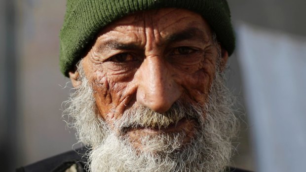 Mohammed Jaafar, 60, a Syrian army soldier from the fourth division poses for a picture in the east Aleppo neighbourhood of Tariq al-Bab.