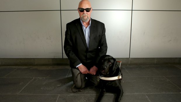 Vision-impaired man Mark Birkett with his guide dog Lester.  