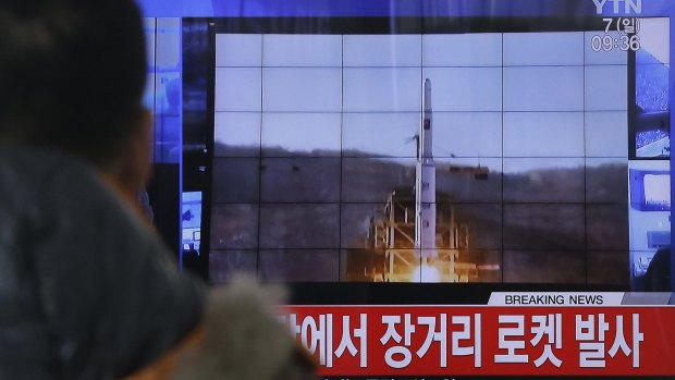 A South Korean man watches a TV news  report on North Korea's rocket launch at Seoul Railway Station.