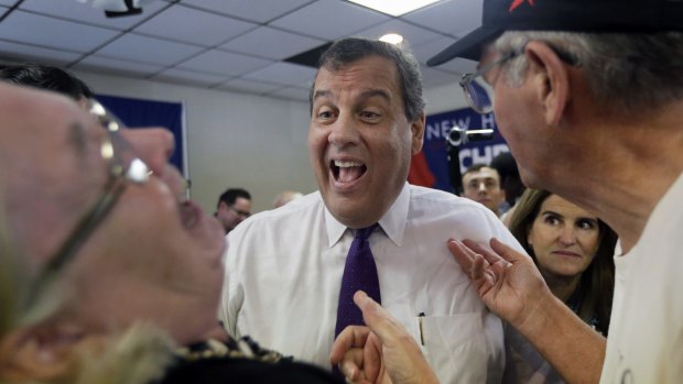 Republican presidential candidate, New Jersey Governor Chris Christie laughs with voters as his wife Mary Pat watches at right, in Rochester, New Hampshire, on Thursday.