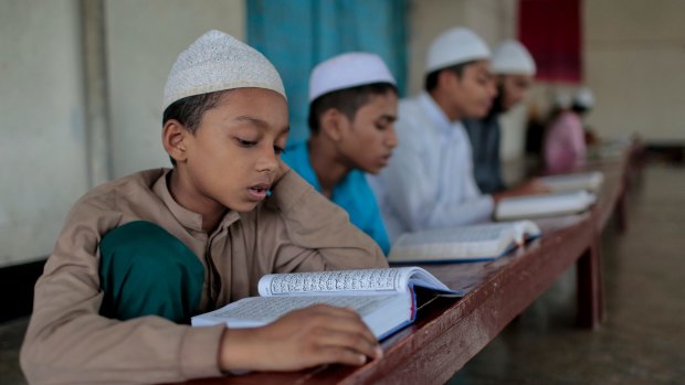 Bangladeshi Muslim students read the holy Koran at an Islamic school during Ramadan in Dhaka, Bangladesh in June 2016. 