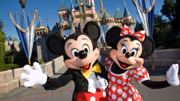 Mickey Mouse and Minnie Mouse welcome visitors to  Disneyland in California.