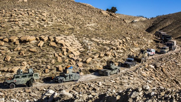 Peshmerga vehicles belonging to the Zeravani Force move through Mount Sinjar, in Iraq, on Thursday. 