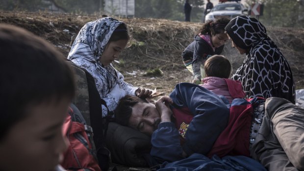 Getting warm with a small fire after crossing the Serbian border into Hungary near the town of Asotthalom on Sunday. 