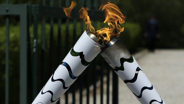 Torch alight: The Olympic flame is symbolically passed from one torch to another after after the official ceremonial lighting of the flame in Ancient Olympia, Greece.