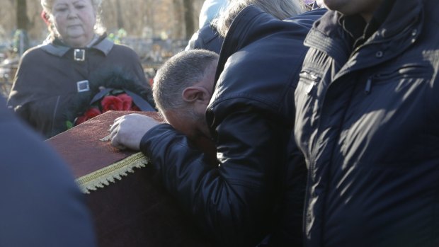 Nina Lushchenko's nephew Pavel mourns at her funeral  in the Russian village of Sitnya on Thursday.