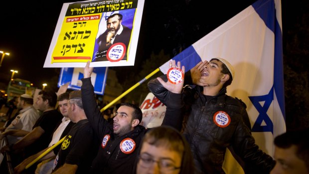 Right-wing Israelis demonstrate at the site of Wednesday's attack by a Palestinian motorist in Jerusalem. The placard shows Rabbi Meir Kahane, a hero to some on Israel's far right.