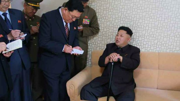 Kim Jong-un takes a rest during his first public appearance for more than a month.