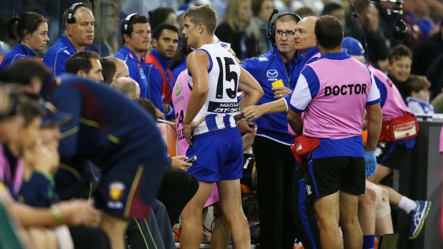 North Melbourne's Nick Dal Santo leaves the field with a hamstring injury on Sunday.