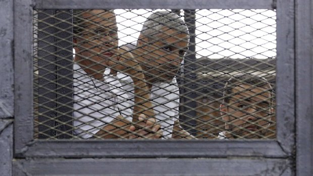 Al-Jazeera journalists (from left) Peter Greste, Mohammed Fahmy and Baher Mohamed  in a Cairo court in June 2014. 