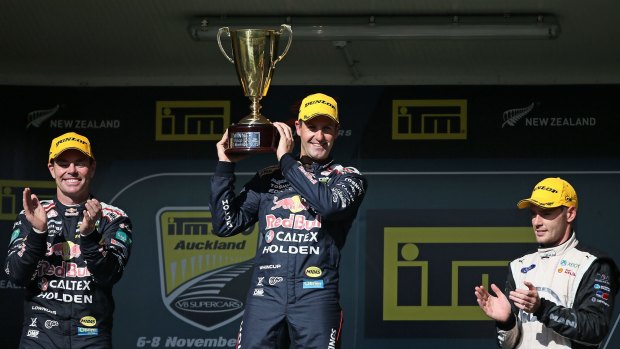 Top step: Jamie Whincup accepts his prize on Sunday alongside teammate Craig Lowndes, left, and third place Scott Pye.
