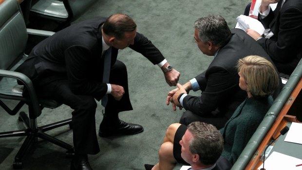 Prime Minister Tony Abbott shows Treasurer Joe Hockey the time.