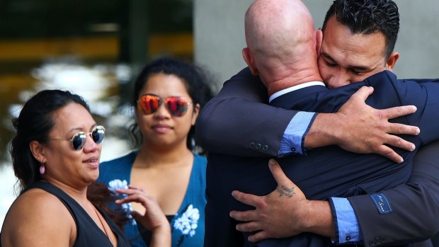 Phillip Pama embraces his lawyer outside the District Court in Brisbane after being found not guilty of manslaughter.