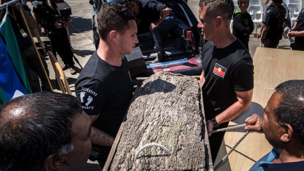 Mungo Man's remains in a red gum casket donated by Dr Bowler are loaded into the hearse.