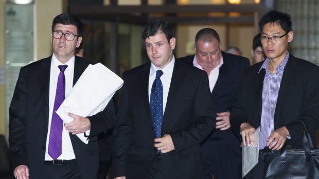 James Ian Longworth, second from left, leaves the Downing Centre District Court.