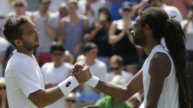 Viktor Troicki shakes hands with Dustin Brown after the match.