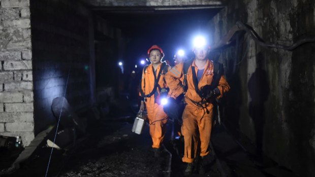 Rescuers work at Jinshangou Coal Mine in Chongqing, south-west China. 