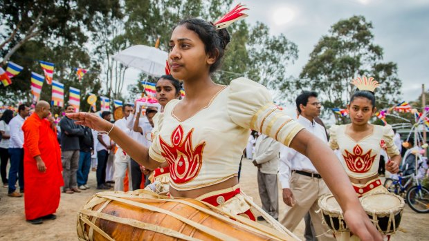 Devotees danced and beat drums as the street parade wound its way around Jenke Circuit to the Sri Lankan Buddhist Temple in Kambah.