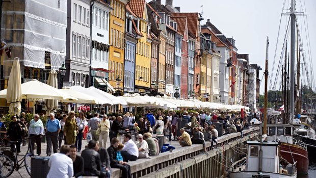 Happy: People enjoying the Nyhan riverside in Denmark. 