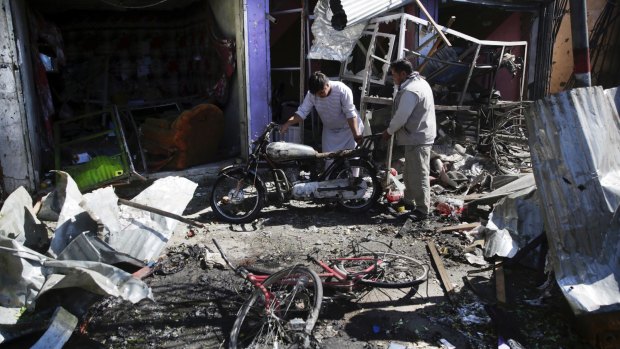 Men at the site of Monday's suicide attack in Kabul.