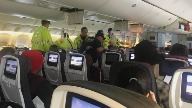 Australian band Hurricane Fall provided this photo of emergency services treating a passenger after an Air Canada flight to Australia hit severe turbulence last week.