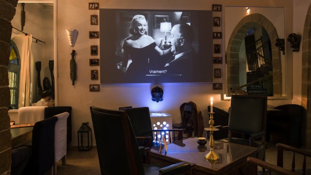 Movies play in a high-ceilinged restaurant that feels like a gentleman's club with its black-and-white decor and Berber artefacts, at La Maison du Cinema.