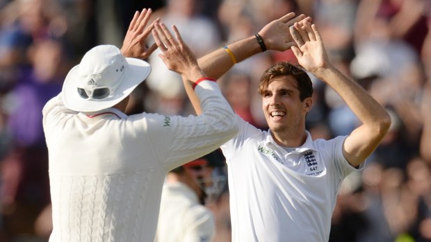 England's Steven Finn celebrates after dismissing Australia's Mitchell Johnson.