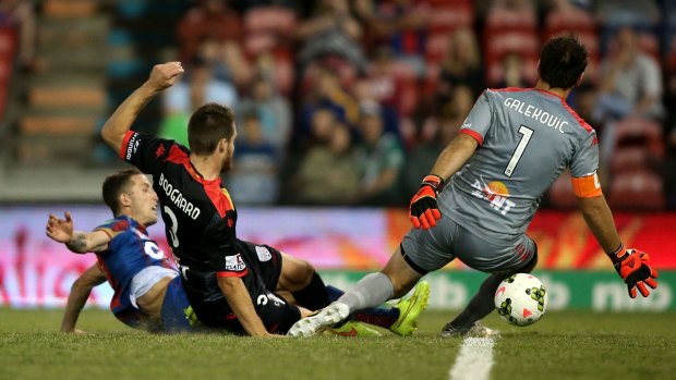 Scott Neville of the Newcastle Jets (left) opens the scoring in A-League match against Adelaide United on Friday.
