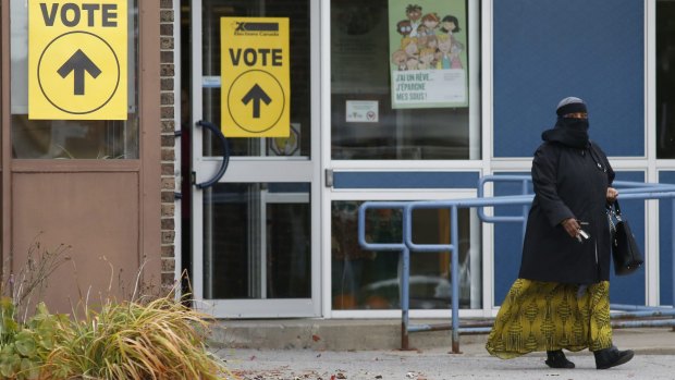 A woman wearing a niqab leaves the Ecole Marius-Barbeau polling station in Ottawa, after casting her vote in the Canadian federal election on Monday.