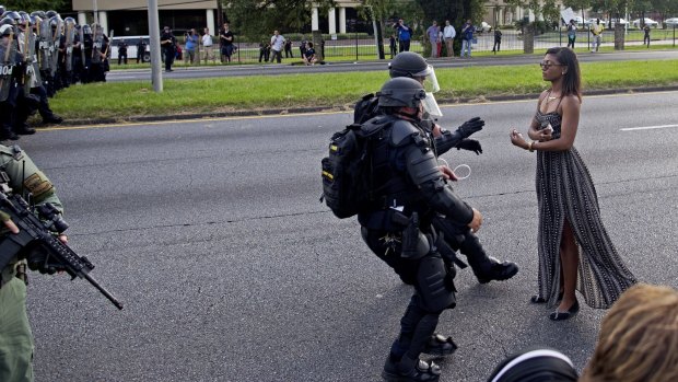 Making a stand: Police officers in riot gear face Leshia Evans during a protest in Baton Rouge.