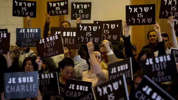 Israelis hold "I am Charlie", "Israel is Charlie" and "I am a Jew of France" signs at a gathering in Jerusalem on Sunday. 