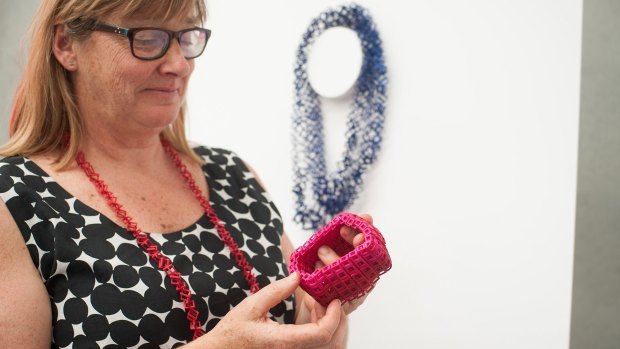 Jeweller Bin Dixon-Ward holding one
 of her 3D printed pieces.